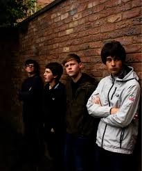 The Fleecers photographed against a brick wall in an alleyway